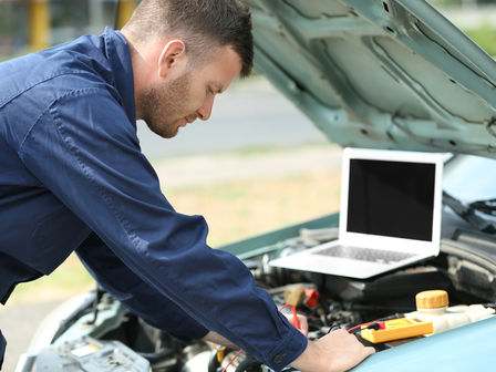 a man using eu22i power generator for mobile car repair on a remote county road