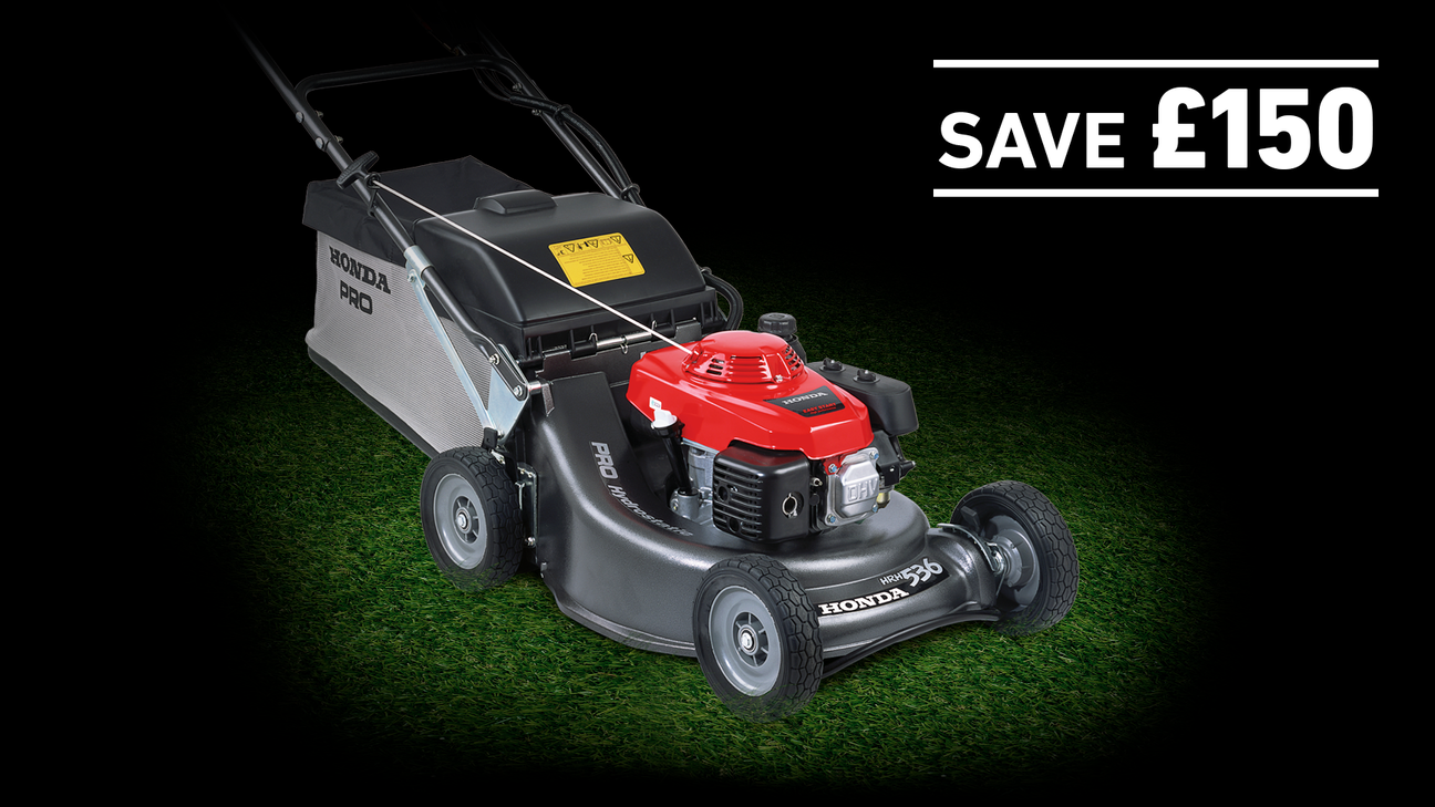 HRH lawnmower on grass in a dark background with save £150