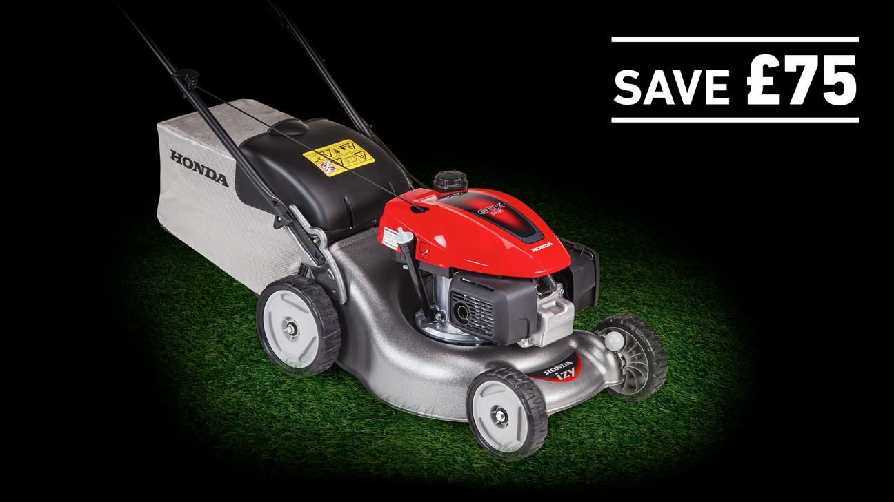 IZY lawnmower on grass in a dark background with save £75