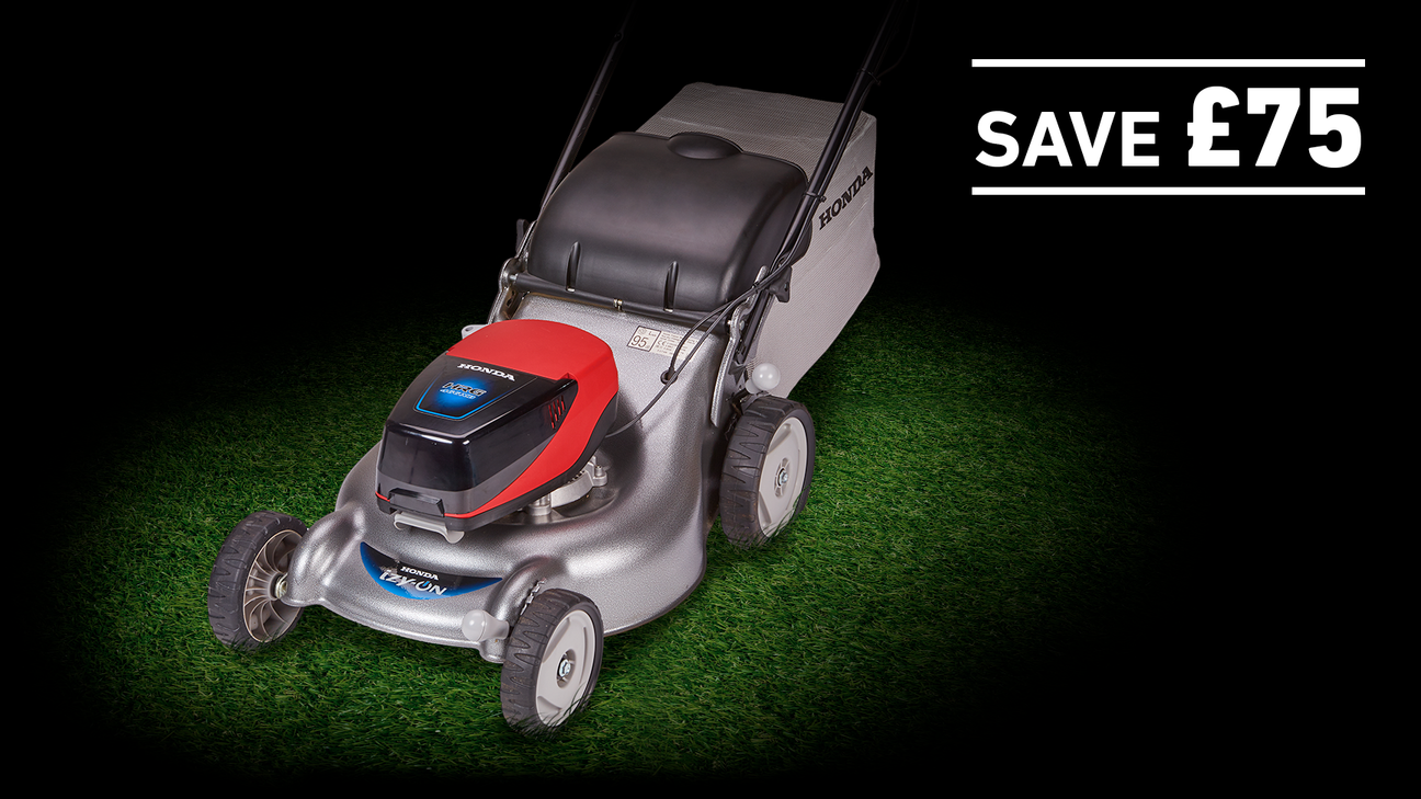 izy-ON lawnmower on grass in a dark background with save £75