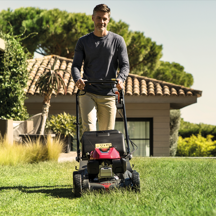 Man pushing IZY lawnmower