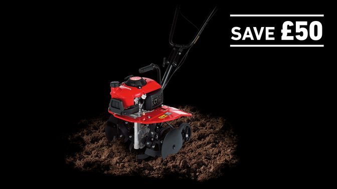 Mini Tiller in soil on a dark background with Save £50