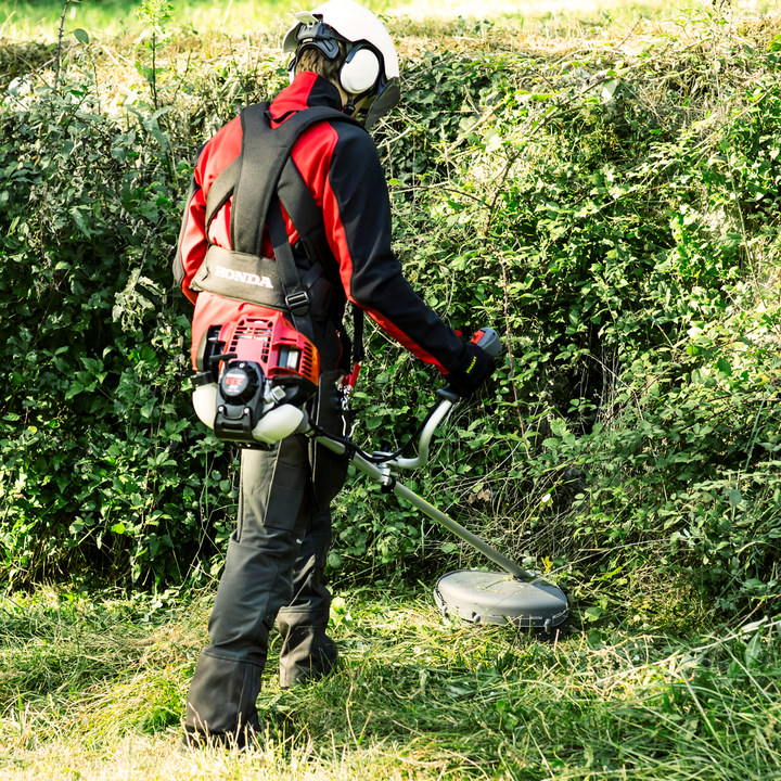 Petrol brushcutter used on bush