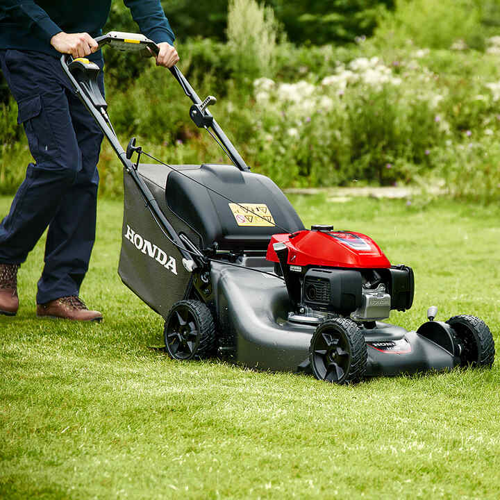Close up of lawnmower working on the lawn.