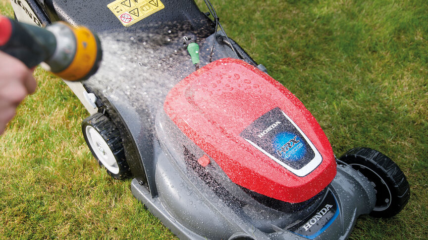 Cordless HRX Xenoy deck being sprayed with a hose