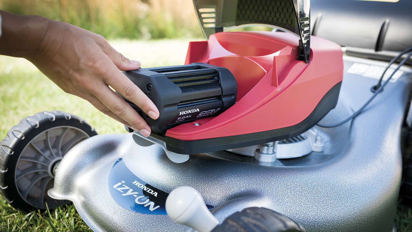 Honda Izy-On battery being put into lawn mower