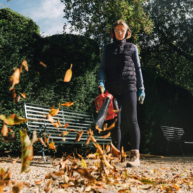 Leafblower being used by model, garden location.