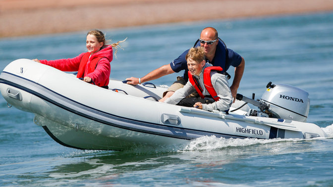 family riding highfield boat with a honda outboard engine
