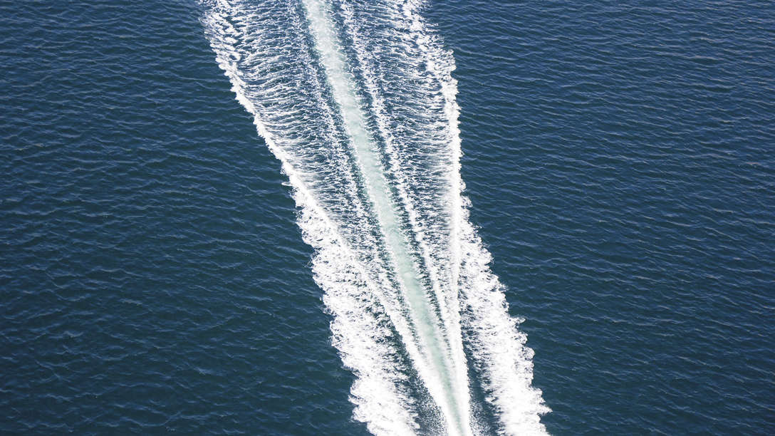 scenic aerial photo of the wake of a powerboat