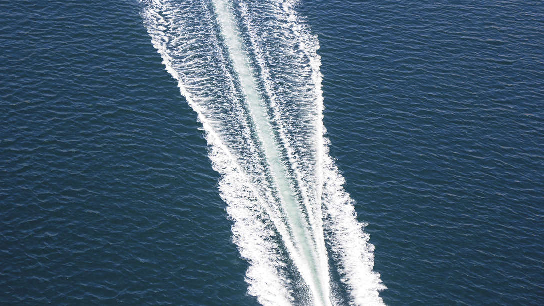scenic aerial photo of the wake of a powerboat
