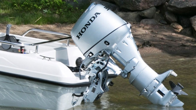 side view of a highfield boat powered by a 30 horsepower honda outboard engine using its trim and tilt