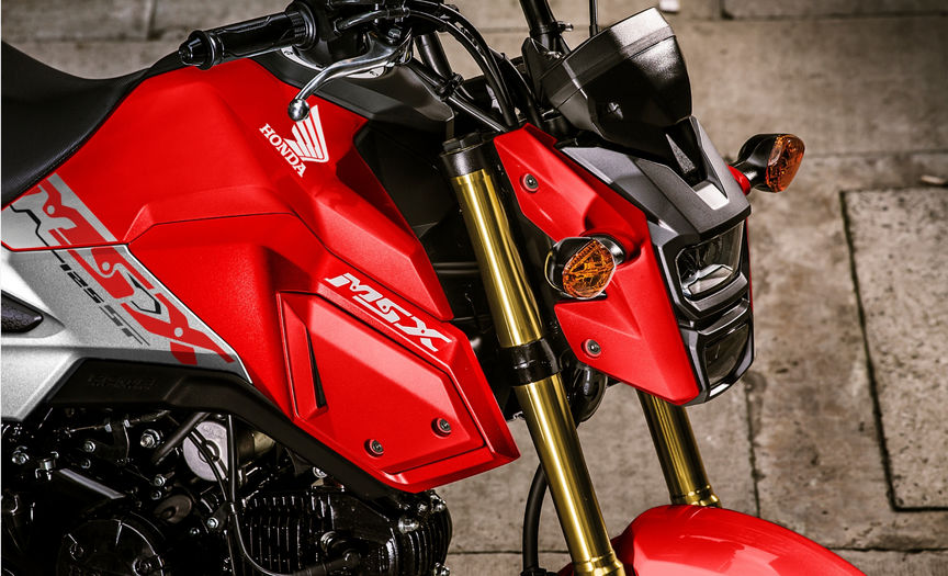 Close up motorcycle wheel with Honda sticker.