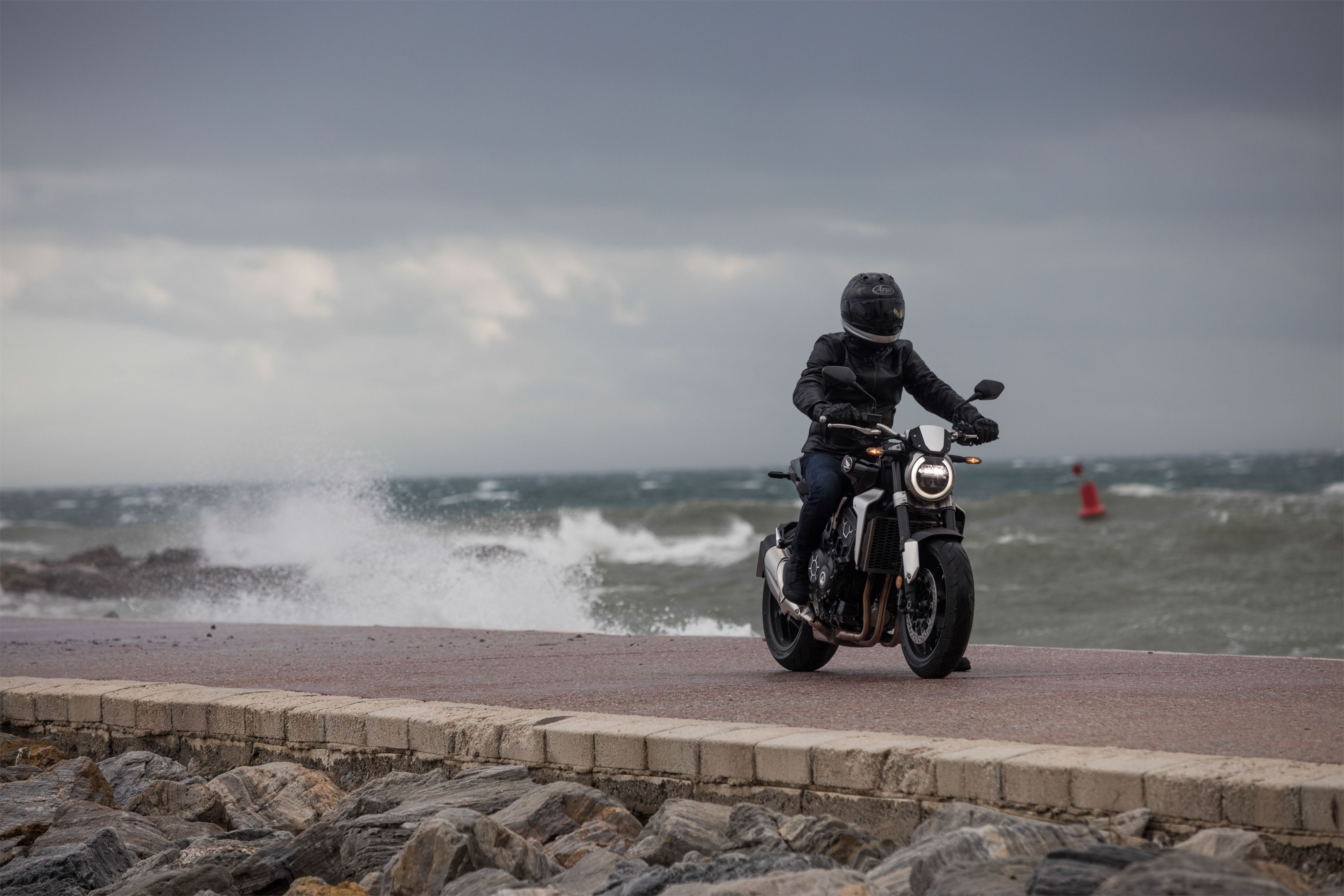 Motorcyclist riding in stormy conditions