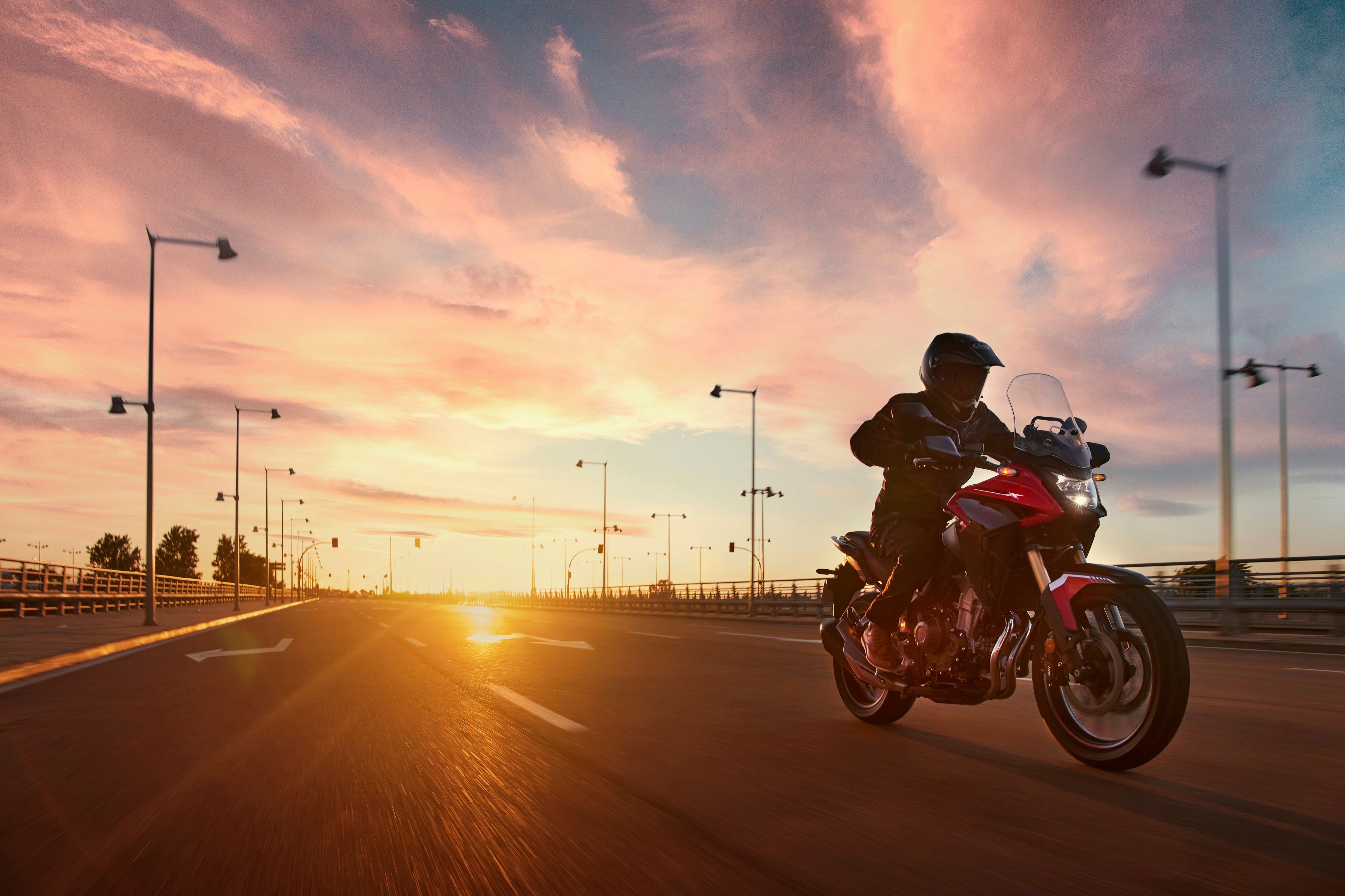 Motorcyclist riding in evening conditions