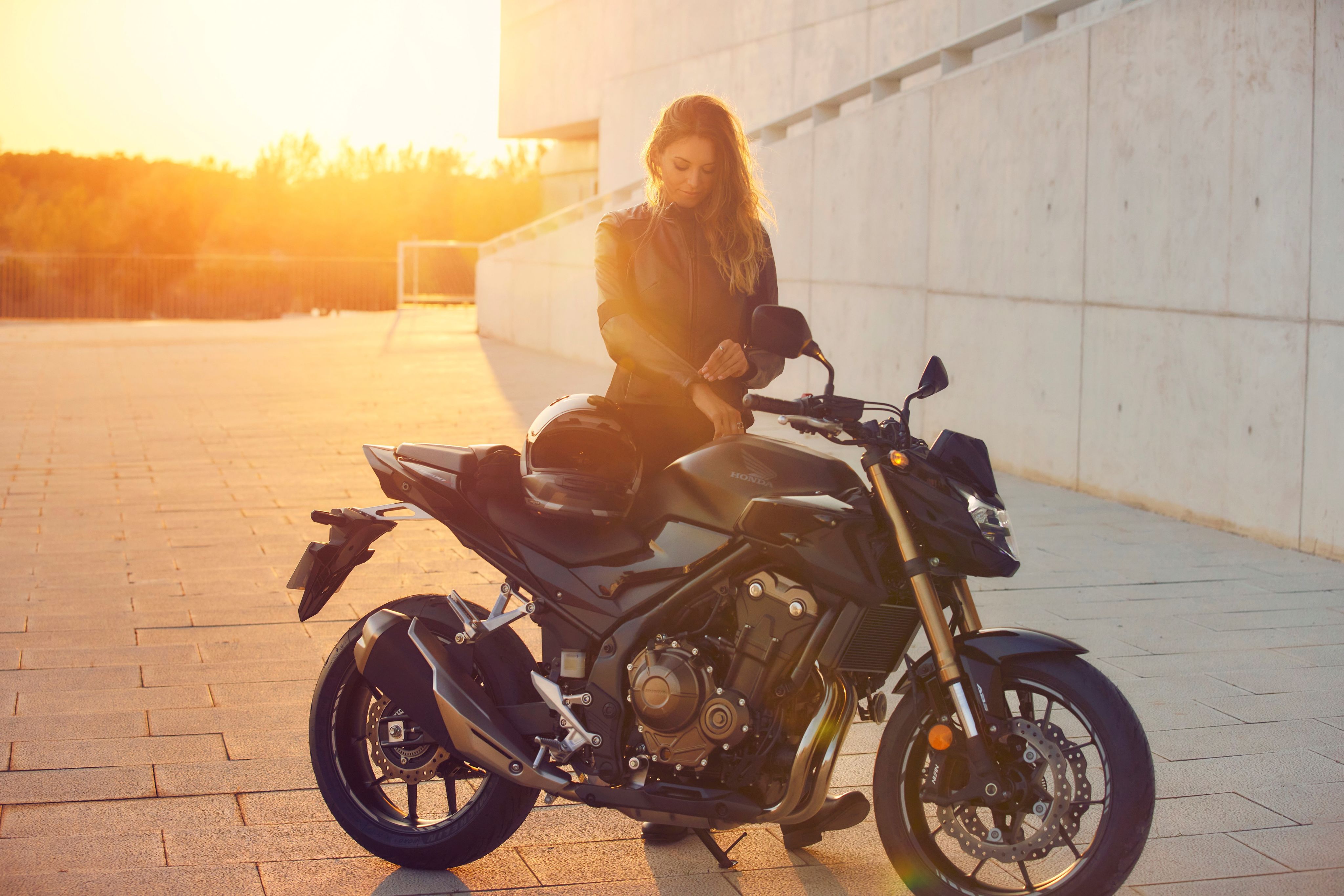 Woman stood next to a motorcycle