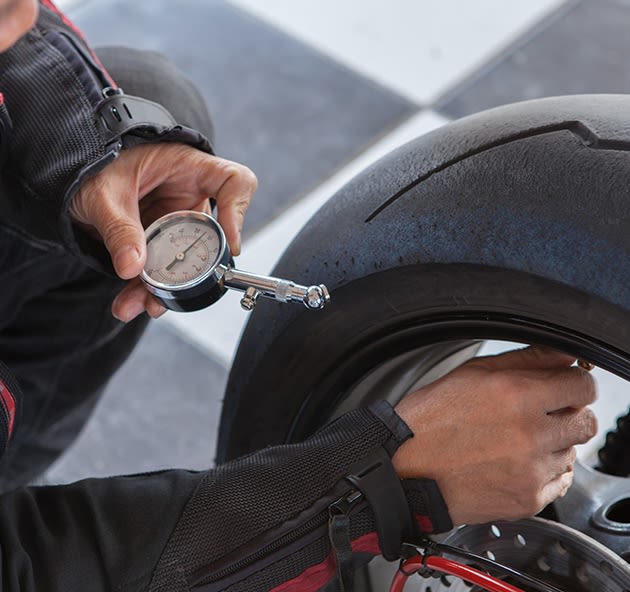 Checking motorcycle tyre pressure