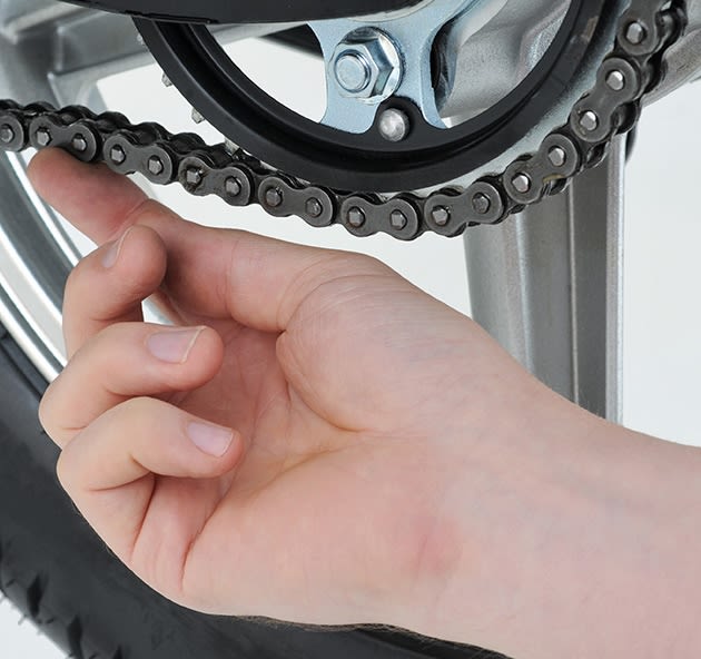 Checking motorbike chain tension