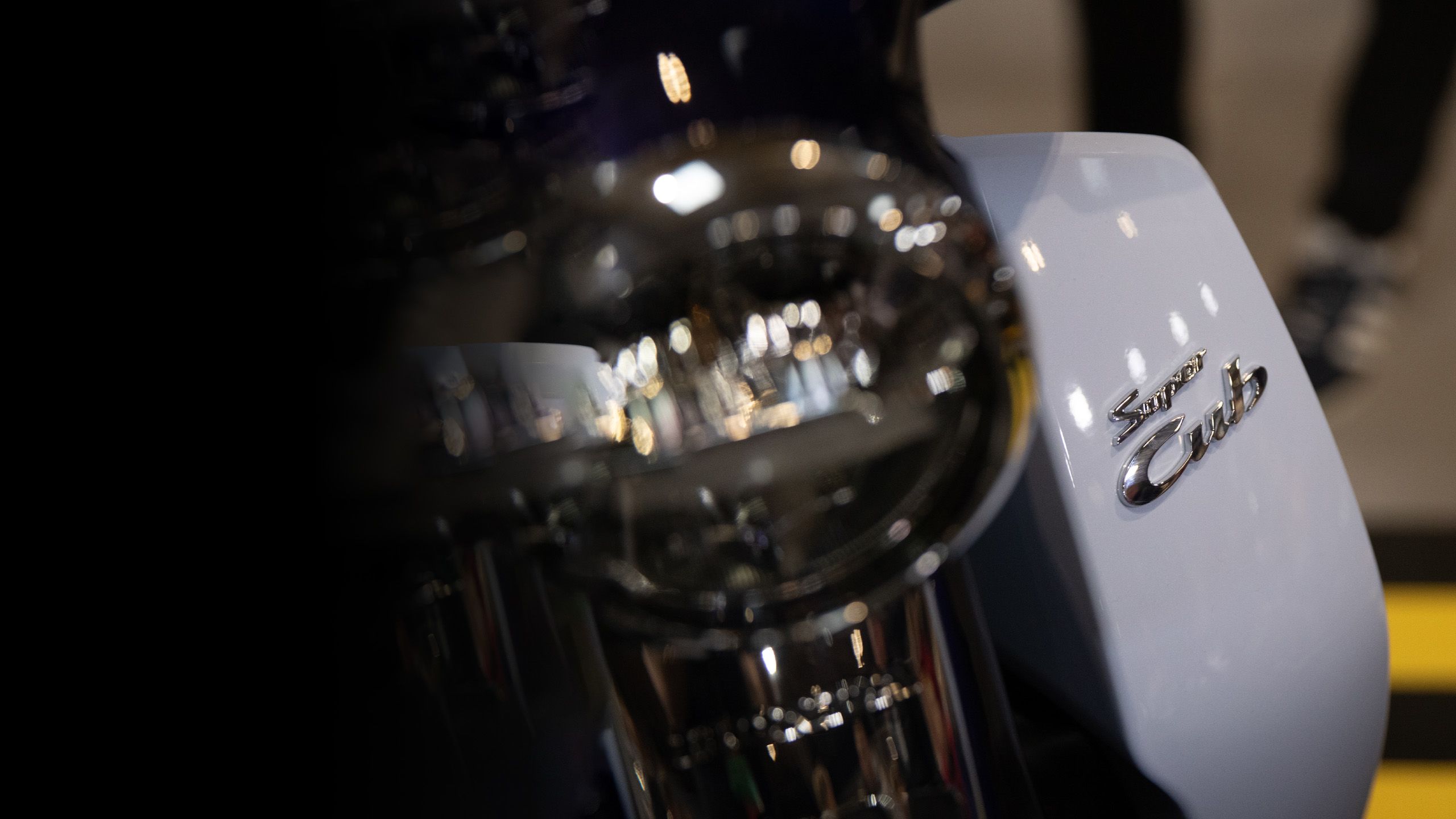 Close up of Honda Super Cub logo and Super Cub headlight