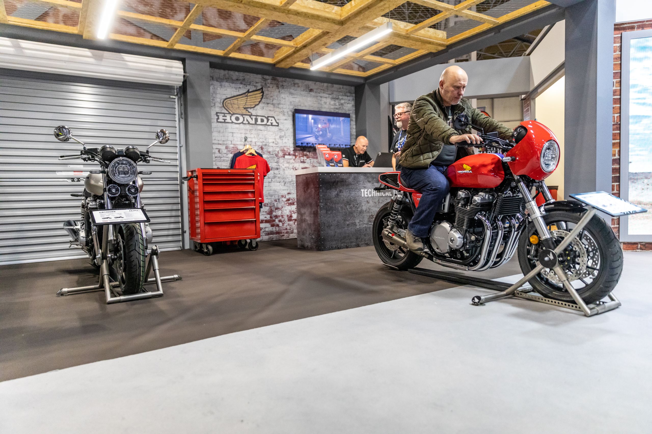 Event attendee sat on CB1100 RS 5Four at the Honda street bike stand at Motorcycle Live 2019