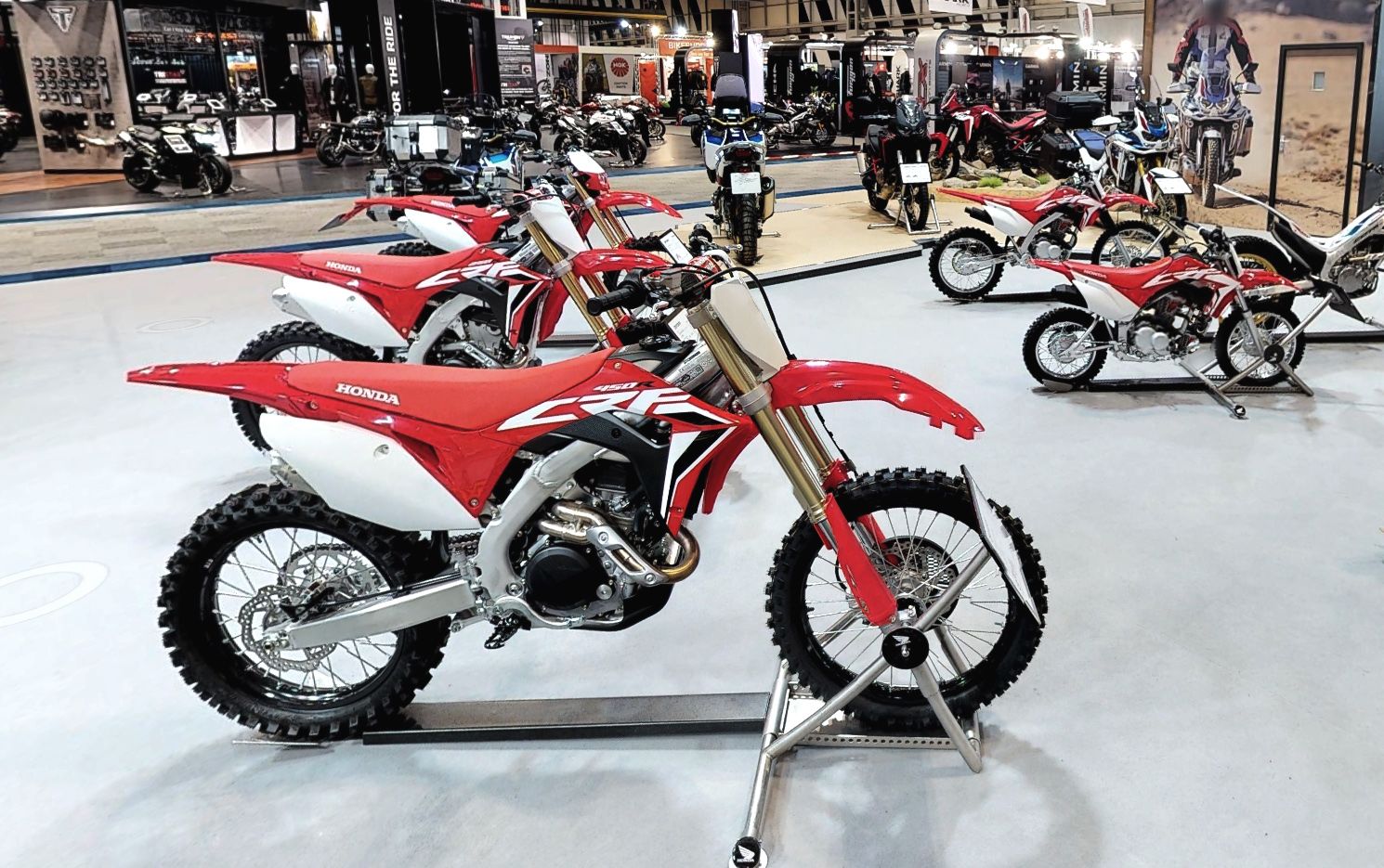 Various Honda off-road motorcycles on stands at Motorcycle Live 2019