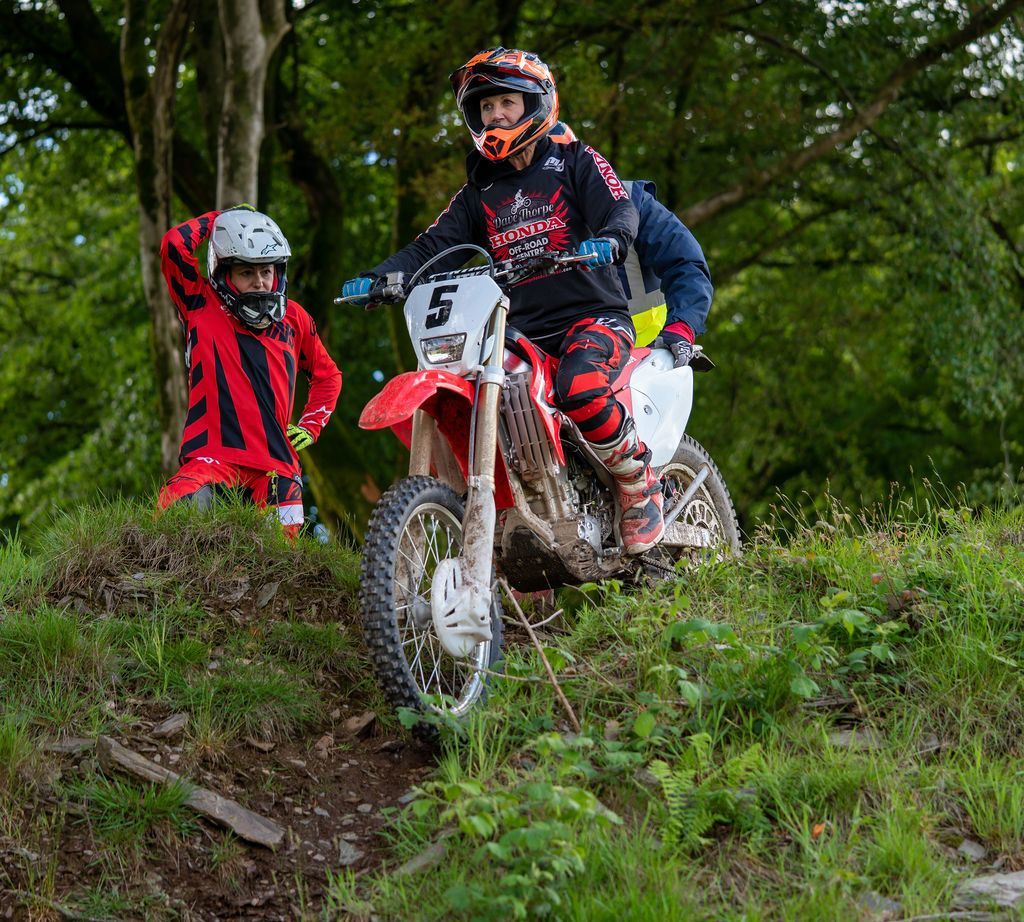 Rider about to go downhill on Honda off-road motorcycle at the Dave Thorpe Off-Road Centre