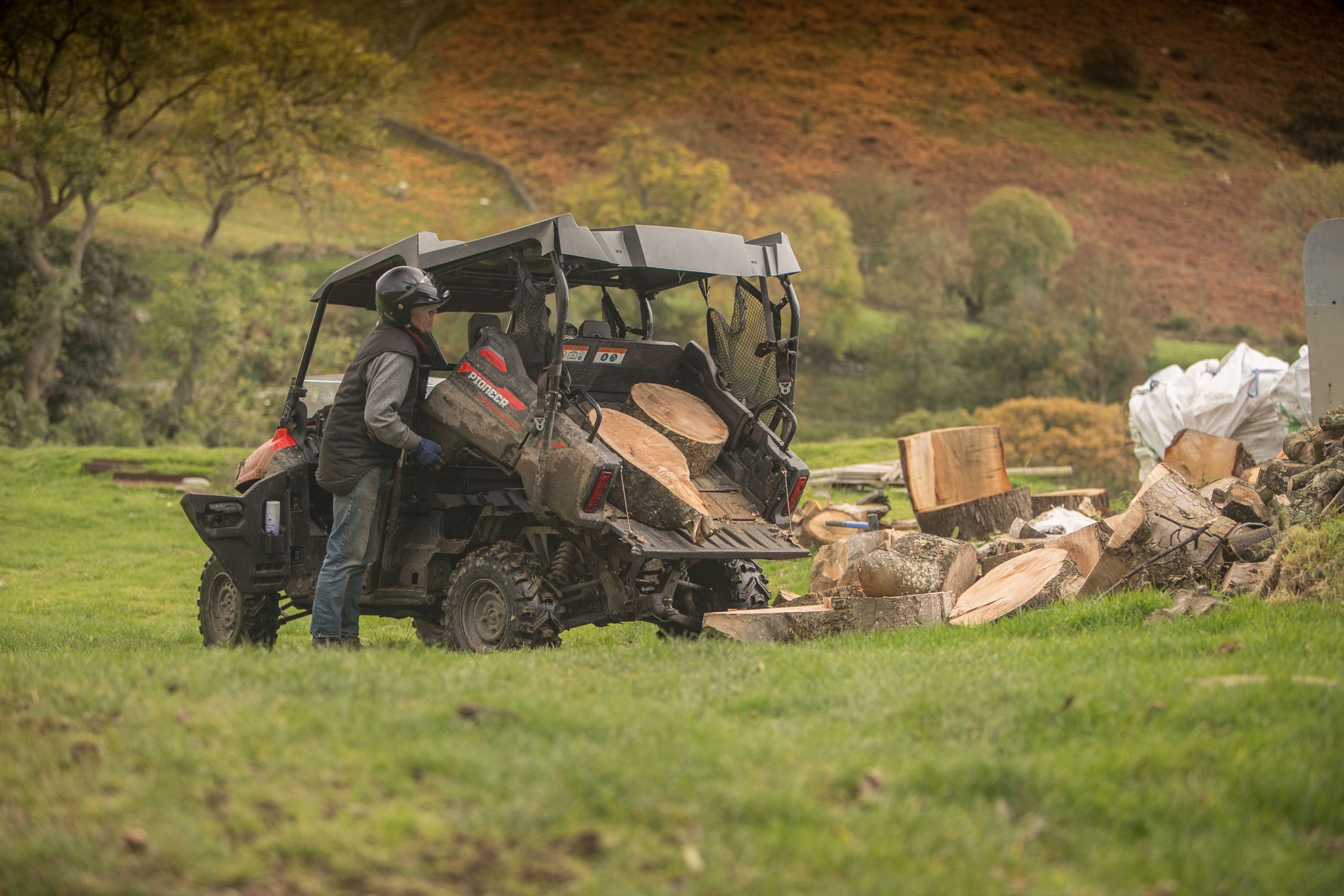 honda pioneer utv carrying logs