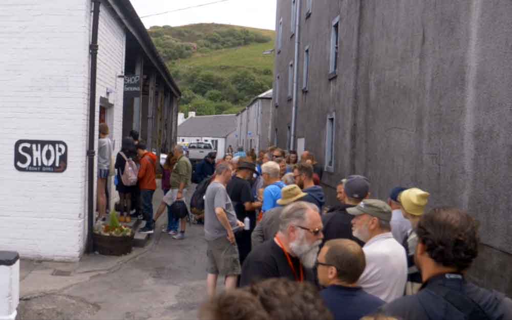 Queue of people outside whisky distillery shop