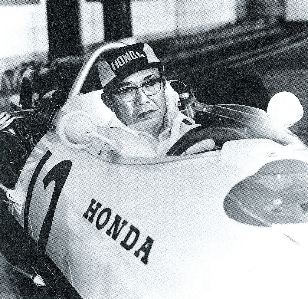soichiro honda in formula 1 car black and white