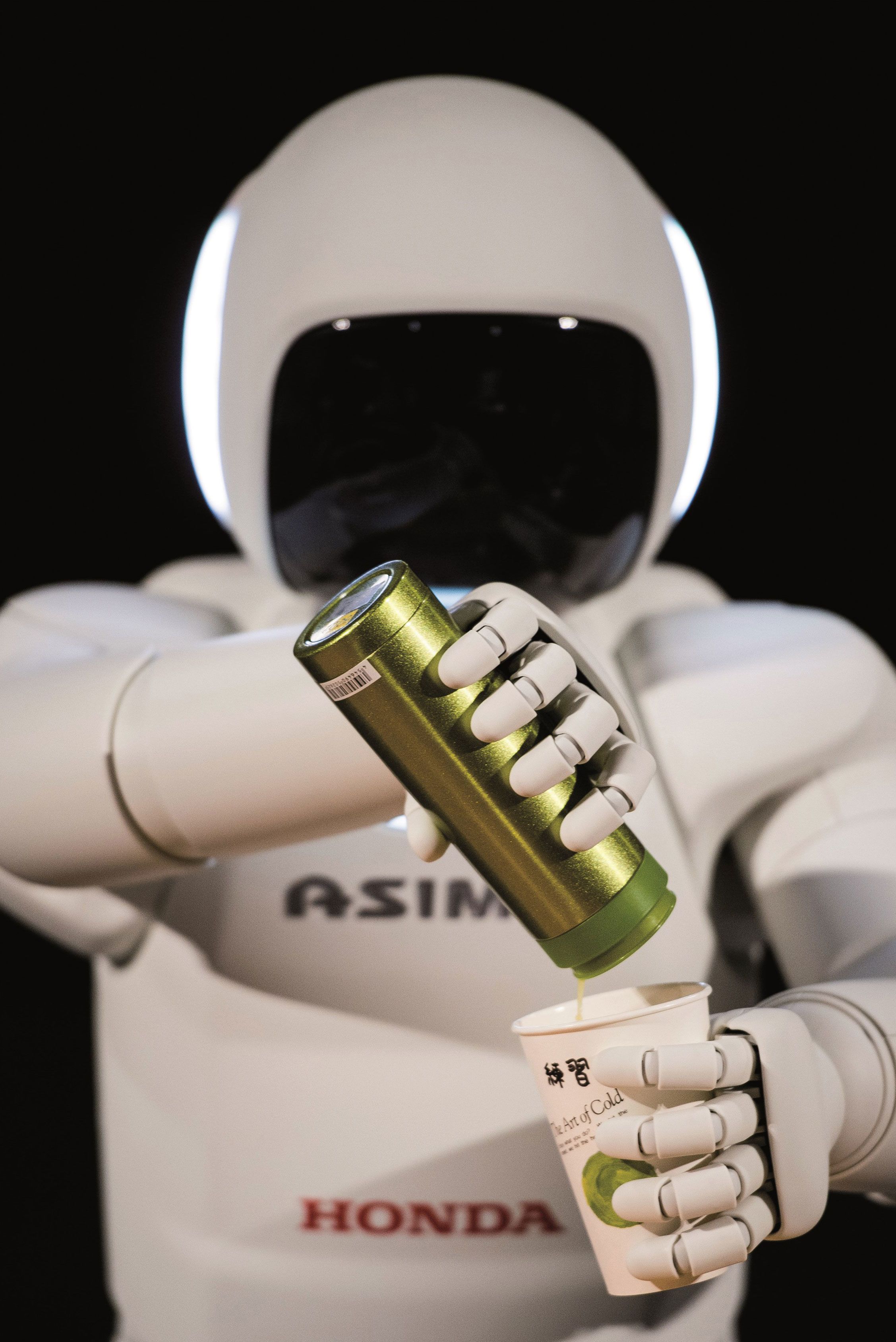 Honda ASIMO humanoid robot opening a drinks can